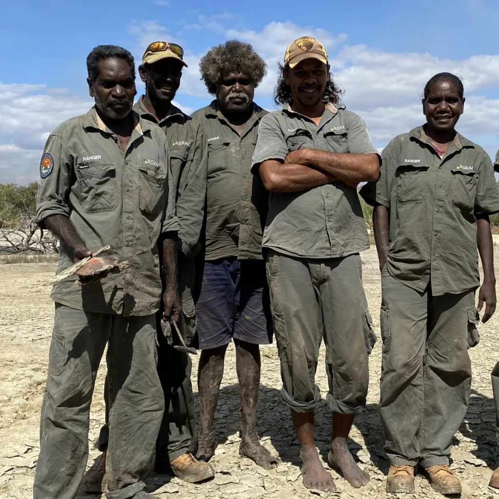 Five Wanga Djakamirr Rangers in uniform on Country. 